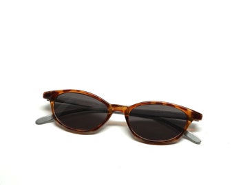 May include: Tortoise shell sunglasses with dark lenses and silver metal arms.