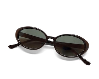 May include: Brown oval-shaped sunglasses with dark lenses.