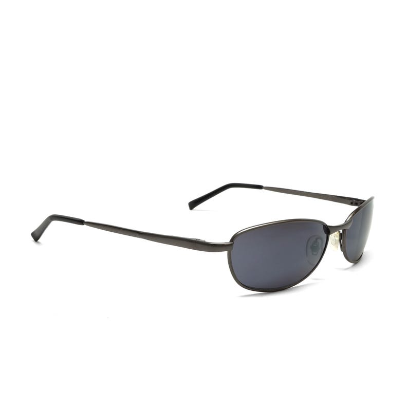 May include: Dark gray sunglasses with oval lenses and thin, straight temples. The sunglasses have a sleek, modern design, suitable for everyday wear. The lenses are a dark gray color.