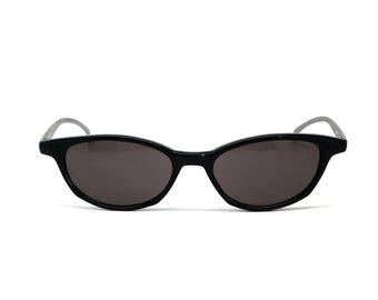 May include: Black oval-shaped sunglasses with dark lenses.