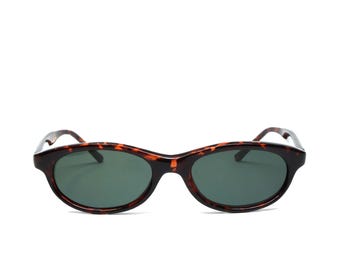 May include: Tortoiseshell oval sunglasses with dark green lenses.