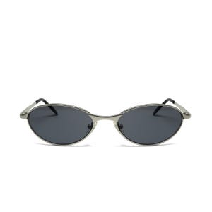 May include: Oval-shaped sunglasses with a silver metal frame and dark lenses. The sunglasses have a sleek, minimalist design, with a thin frame and curved temples. A stylish accessory for eye protection.