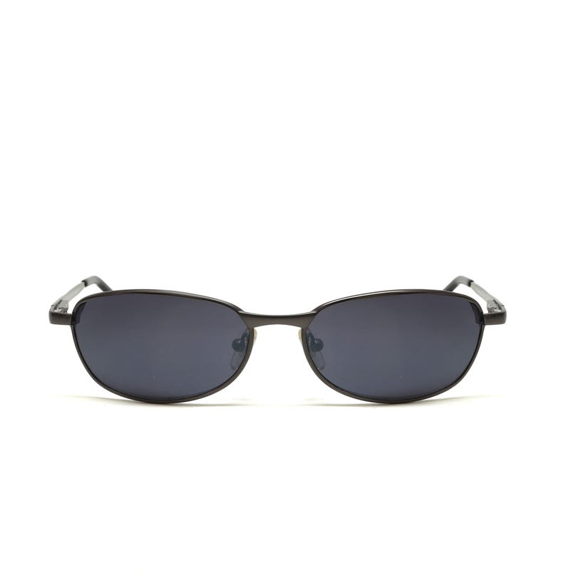 May include: Black oval sunglasses with dark lenses. The sunglasses have a thin, black metal frame and a classic, minimalist design. The lenses are a dark, solid color, providing a sleek and stylish look.