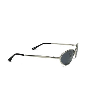 May include: Silver-framed sunglasses with oval lenses and black temples. The sunglasses have a sleek, modern design, suitable for various face shapes. The lenses are a dark gray color, offering protection from the sun.