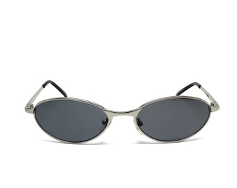 May include: Oval-shaped sunglasses with a silver metal frame and dark gray lenses. The sunglasses have a sleek, minimalist design with thin temples and a classic, retro aesthetic. The lenses are slightly curved.