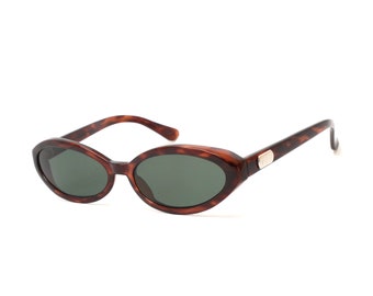 May include: Tortoise shell oval sunglasses with dark green lenses.