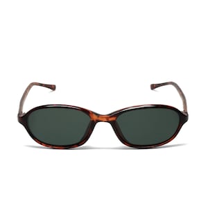 May include: Tortoise shell oval sunglasses with dark green lenses.