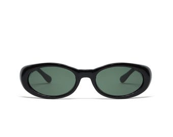 May include: Black oval sunglasses with dark green lenses.