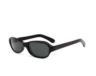 May include: Black oval sunglasses with dark lenses. The sunglasses have a simple, classic design.