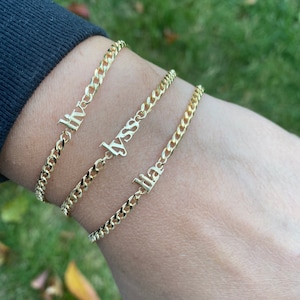 Custom name bracelet on a cuban link chain. Personalized name bracelet on a curb chain. Sterling silver gold plated nameplate bracelet.