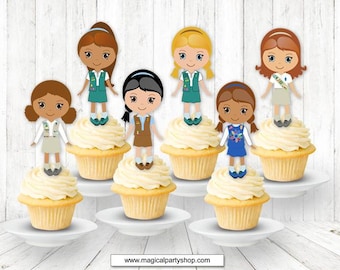 Puede incluir: Seis cupcakes decorados con diferentes adornos temáticos de Girl Scout. Los adornos son de diferentes colores y tienen diferentes diseños. Los cupcakes son todos blancos con glaseado amarillo.
