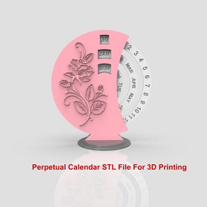 Puede incluir: Un calendario perpetuo rosa con un diseño de rosa en la parte delantera. El calendario tiene un dial giratorio con los días de la semana y los meses del año. El calendario está sobre una base gris.