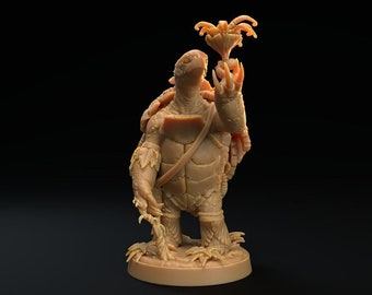 May include: A detailed miniature figurine of a turtle-like creature holding a flower. The figurine is made of a light brown material and is standing on a circular base.