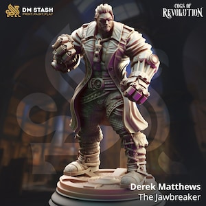 May include: A detailed miniature figurine of a man with a beard and a mechanical arm, wearing a long coat and holding a weapon. The figurine is painted in a brown and grey color scheme. The text "Derek Matthews The Jawbreaker" is printed below the figurine.