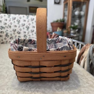 May include: A rustic wooden sign with the text "Welcome to our home" in white lettering. The sign features a distressed finish and a simple, inviting design, perfect for a front porch or entryway.
