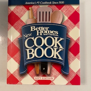 May include: A blue cookbook with a red and white checkered background. The cover features a red spatula, a wooden rolling pin, and a wooden spoon. The title is "New Better Homes and Gardens Cookbook" and the text "Gift Edition" is at the bottom.