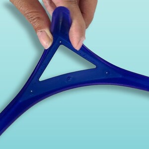 May include: A blue plastic tool shaped like a triangle with three curved arms. The tool is designed to help with applying makeup.
