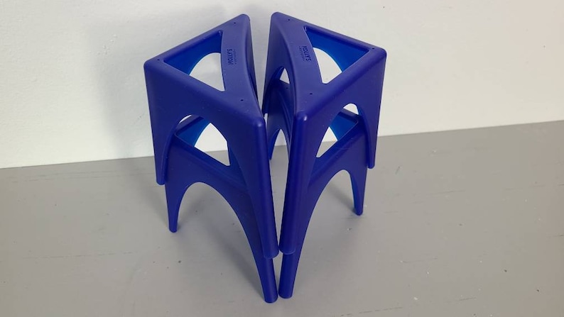 May include: Three blue plastic triangular stools stacked on top of each other. The stools are made by the company "Little" and "Step2".