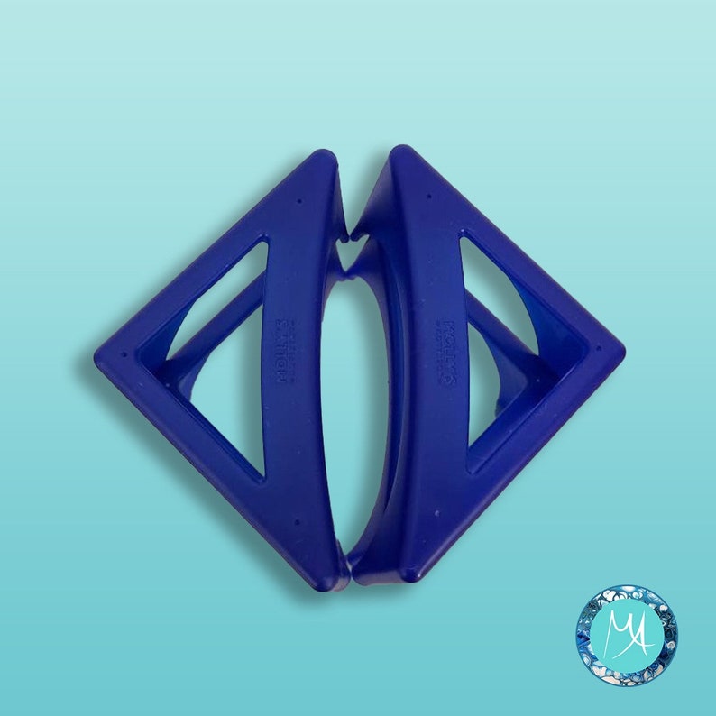 May include: A pair of blue plastic hair clips in the shape of a triangle. The clips are designed to hold hair in place.
