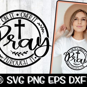 May include: Black and white graphic design with a cross and the text "On it, Over it, Pray, Through it."  The design is in a circle with leaves around it.