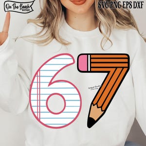 May include: White sweatshirt with a graphic design featuring the number 6 with lined paper and the number 7 shaped like a pencil. The pencil is orange with a pink eraser and black tip. Text at the top says "SVG PNG EPS DXF".
