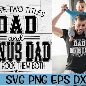 May include: A black and white graphic design with the text "I have two titles Dad and Bonus Dad and I rock them both". The graphic is on a white wood background. A man is holding a child on his shoulders. The child is wearing a blue shirt. The man is wearing a black t-shirt with the same graphic design in white.