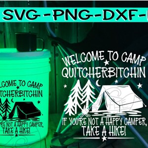 May include: A white bucket with a green glow, featuring the text "Welcome to Camp Quitchherbitchin" and "If you're not a happy camper, take a hike!" The bucket is sitting on a wooden surface.