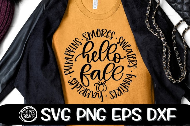 May include: A mustard yellow t-shirt with a black circle graphic that says "hello fall" surrounded by the words "pumpkins, s'mores, sweaters, bonfires, hayrides".