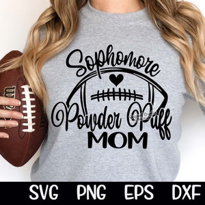 May include: Gray sweatshirt with black text that reads "Sophomore Powder Puff Mom" with a black and white football graphic and a small heart.