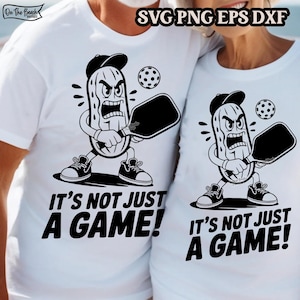 May include: White t-shirts with a black and white graphic of a pickle character playing pickleball. The text "IT'S NOT JUST A GAME!" is printed below the graphic. The image also includes the text "SVG PNG EPS DXF".