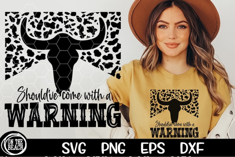 May include: A black and white cow skull graphic with a leopard print background. The text "Should've come with a WARNING" is below the skull. The graphic is on a white background.