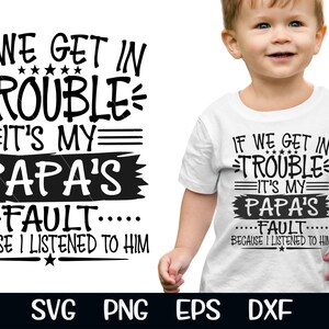May include: White toddler t-shirt with the text "IF WE GET IN TROUBLE IT'S MY PAPA'S FAULT BECAUSE I LISTENED TO HIM" in black. The shirt is worn by a young child.