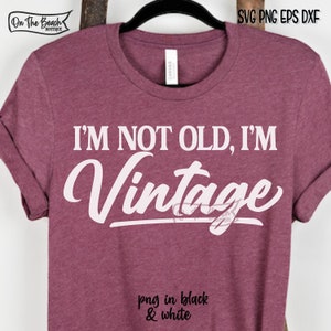 May include: A maroon t-shirt with the text "I'M NOT OLD, I'M Vintage" in white lettering. The text is in a stylized font.