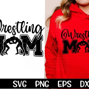 May include: Black and white design of two wrestlers in a wrestling match with the text "Wrestling Mom" in a black and white honeycomb pattern.