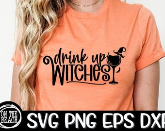 May include: Orange t-shirt with the phrase "drink up WITCHES" in black script, accompanied by a witch hat and wine glass graphic. The shirt also has the text "SVG PNG EPS DXF" at the bottom.