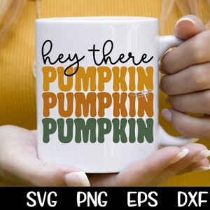 May include: White ceramic mug with the text "hey there pumpkin pumpkin pumpkin" in black, orange, and green lettering.