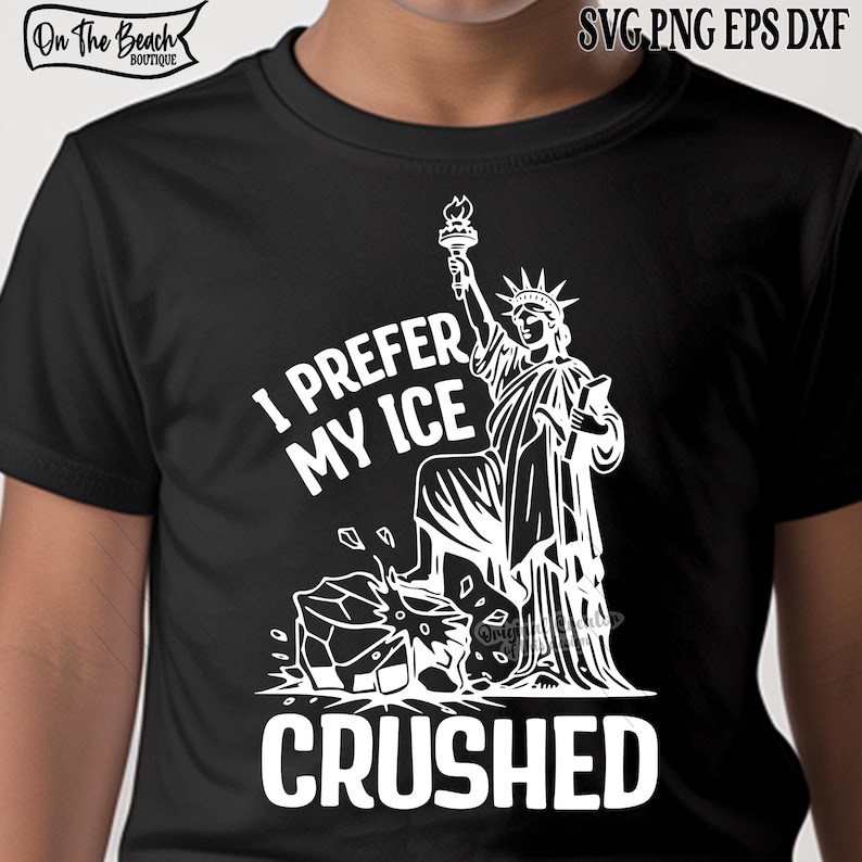 May include: Black t-shirt with a white graphic of the Statue of Liberty holding a torch, with the text "I PREFER MY ICE CRUSHED". The shirt also has the text "On The Beach Boutique" at the top left.