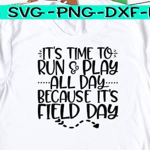 May include: White t-shirt with black text that reads "It's time to run & play all day because it's field day". The text is in a playful font and includes a small heart and dashed lines.