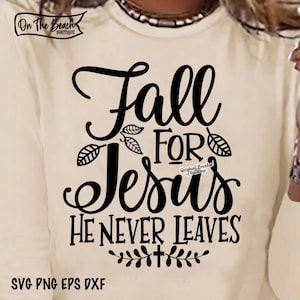 May include: Black and white graphic design with the text "Fall for Jesus He Never Leaves". The design features stylized leaves and a cross.