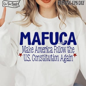 Peut inclure: Sweat-shirt blanc avec le texte bleu "MAFUCA" et la phrase "Make America Follow the U.S. Constitution Again." Le design comprend des étoiles rouges. Le sweat-shirt porte le logo "On The Beach Boutique".