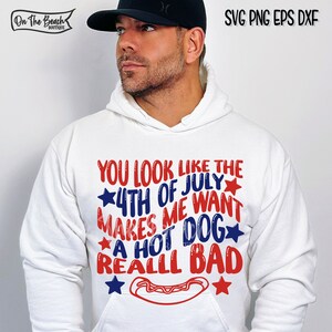 May include: White hoodie with red, white, and blue text that reads "You look like the 4th of July makes me want a hot dog really bad". The text is surrounded by stars. A red hot dog is pictured below the text.