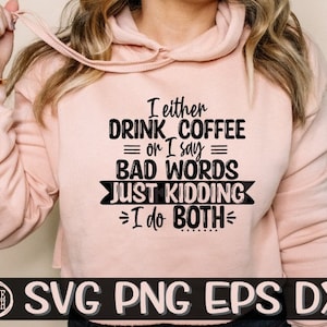 May include: A pink hoodie with a black graphic that reads "I either drink coffee or I say bad words. Just kidding, I do both."