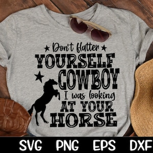 May include: A gray t-shirt with a black silhouette of a horse and the text "Don't flatter yourself cowboy I was looking at your horse".