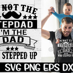 May include: A black and white graphic design with the text "I'm not the stepdad I'm the dad who stepped up" with a mustache and stars. A man is holding a child on his shoulders. The child is wearing a blue shirt. The man is wearing a black t-shirt with the same graphic design.