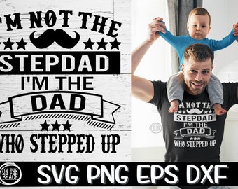 May include: A black and white graphic design with the text "I'm not the stepdad I'm the dad who stepped up" with a mustache and stars. A man is holding a child on his shoulders. The child is wearing a blue shirt. The man is wearing a black t-shirt with the same graphic design.