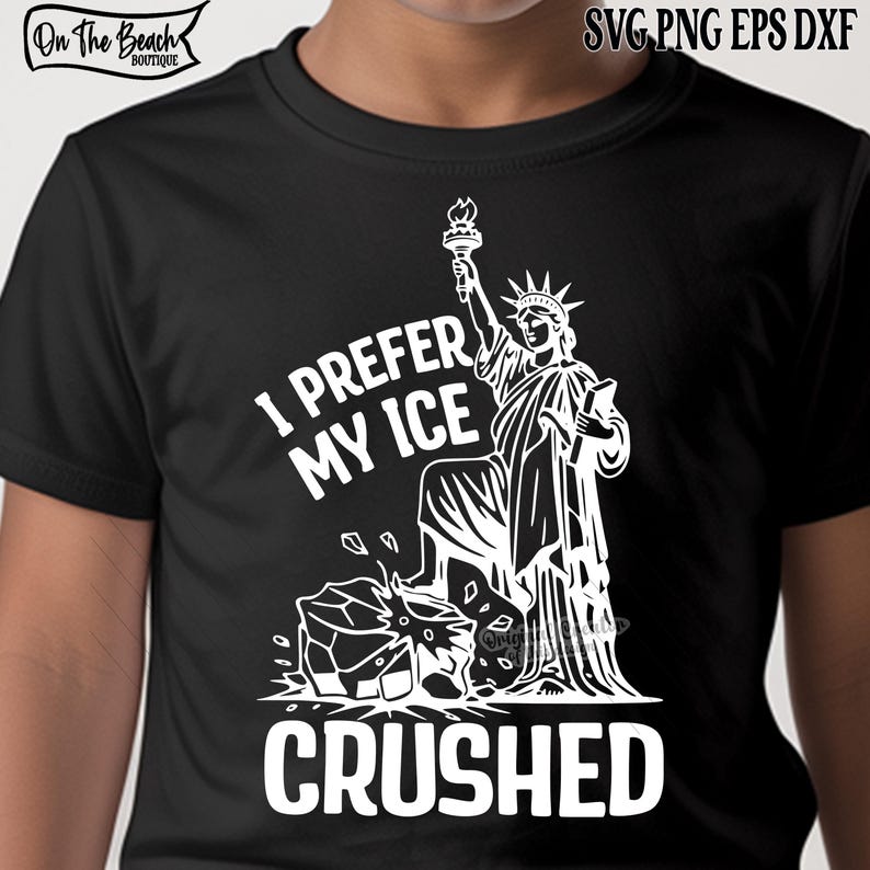 May include: Black t-shirt with a white graphic of the Statue of Liberty holding a torch, with the text "I PREFER MY ICE CRUSHED". The shirt also has the text "On The Beach Boutique" at the top left.