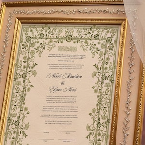 May include: A framed wedding certificate with a floral border in shades of green. The certificate is for Noah Ibrahim and Elyza Noor. The text includes the date of the wedding, August 20, 2023, and the location, Birmingham, Alabama.