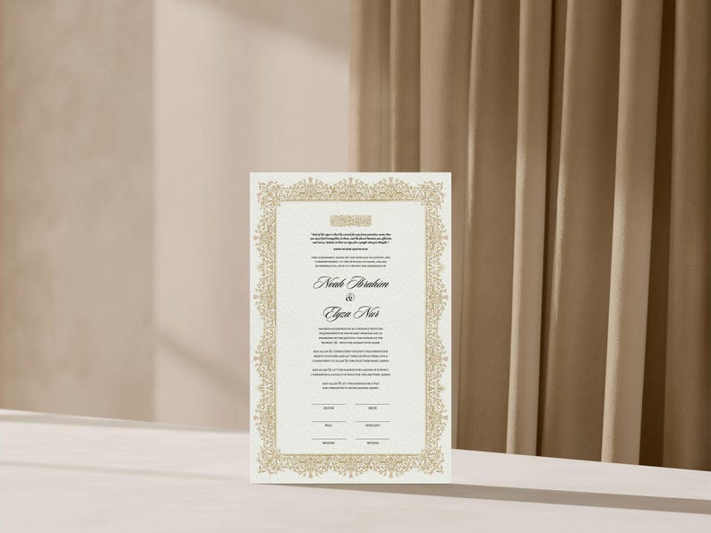 May include: A rectangular wedding invitation card featuring a detailed gold filigree border on a textured white background. The text includes the names Noah Ibrahim and Elyza Nur in a black script font, with additional printed details and lines.