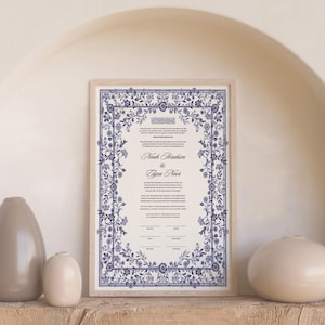 May include: A framed Ketubah with a blue and white floral design. The text reads "Noah Abraham & Gwen Novet".