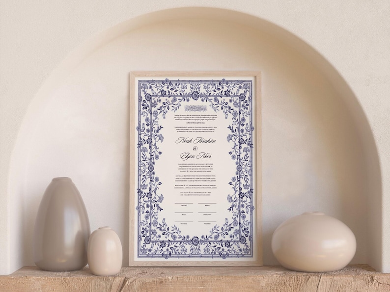 May include: A framed Ketubah with a blue and white floral design. The text reads "Noah Abraham & Gwen Novet".